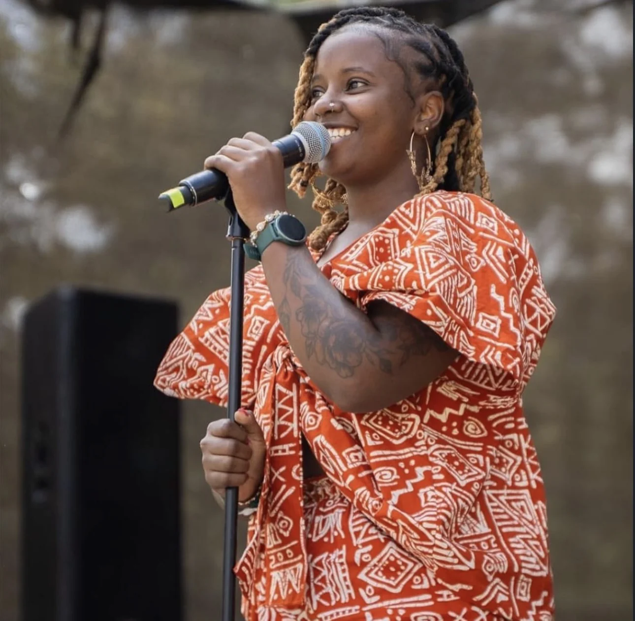 Female vocalist singing a soulful performance under a spotlight